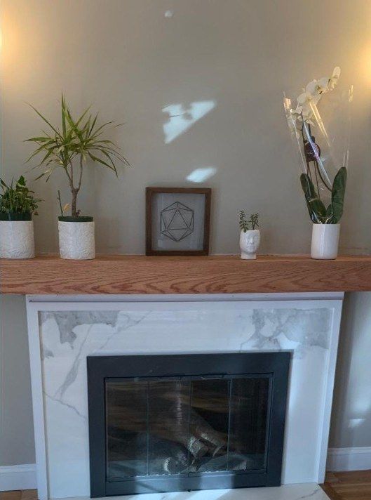 After: fireplace surround retiled with marble-look tile