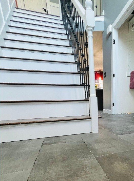After: foyer floor tile replacement by the staircase in Marlborough, MA