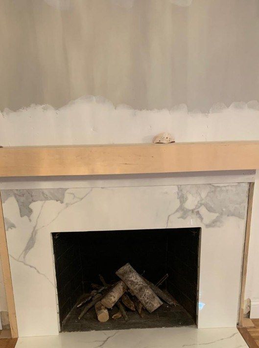 Before: fireplace surround retiled with marble-look tile