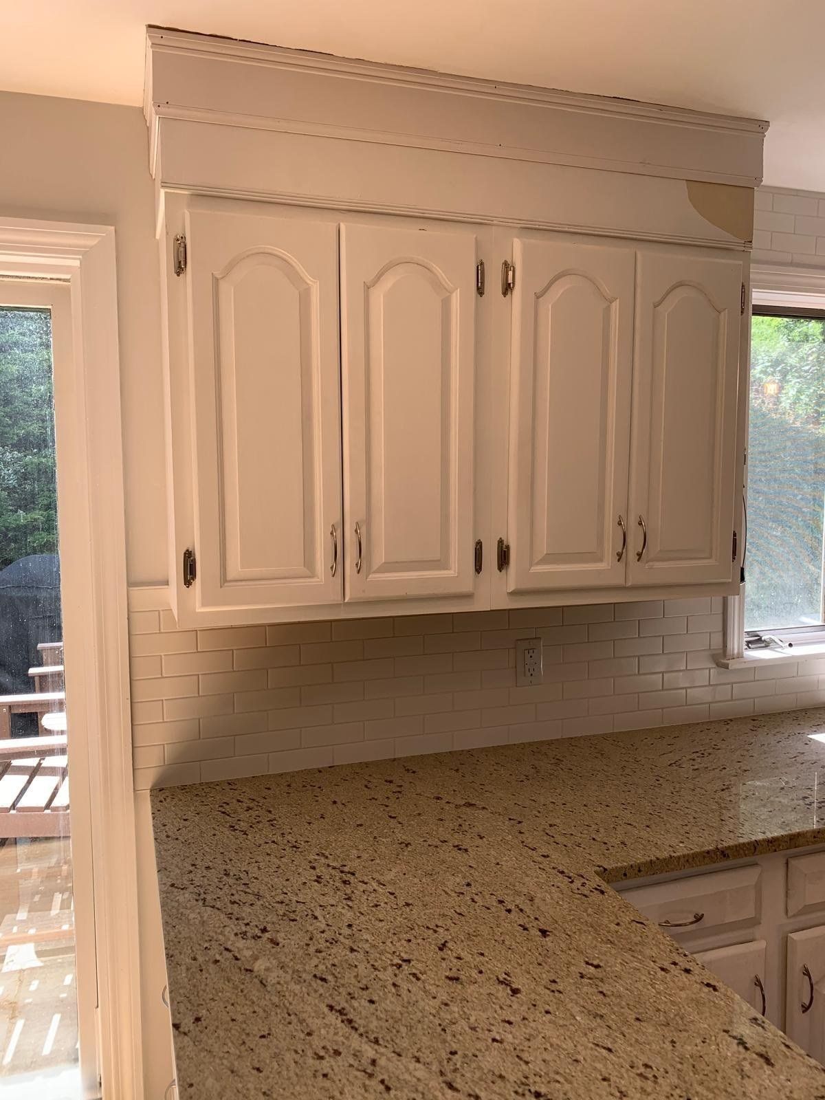 Granite countertop with white subway tile backsplash