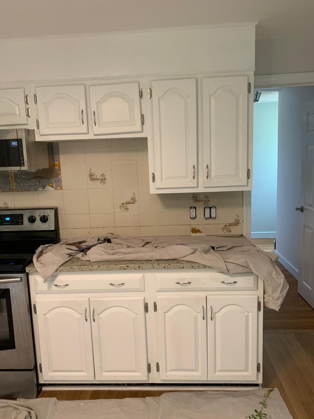 Kitchen cabinets prepped and painted, counters protected
