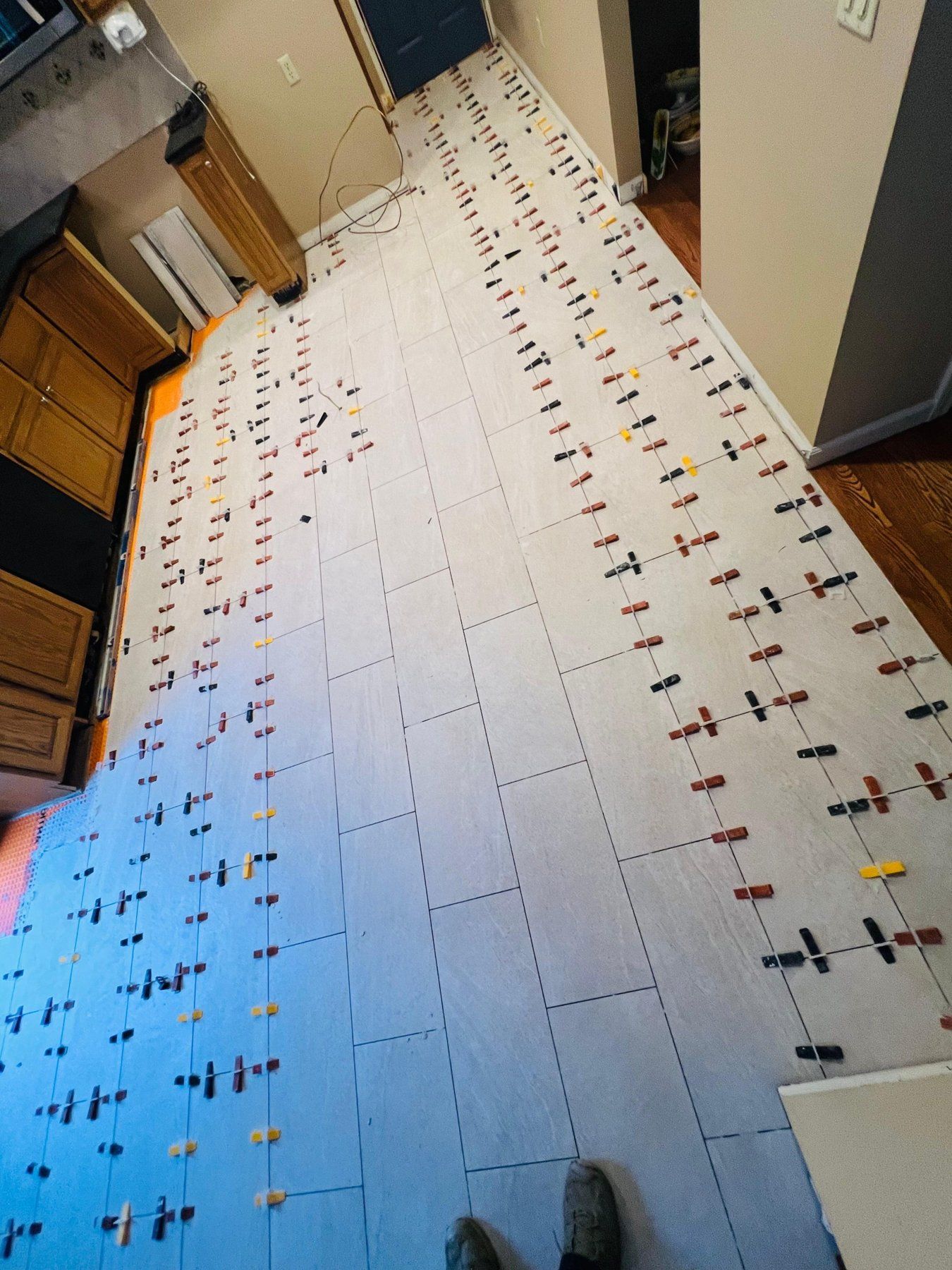 Tile leveling clips during a kitchen floor installation