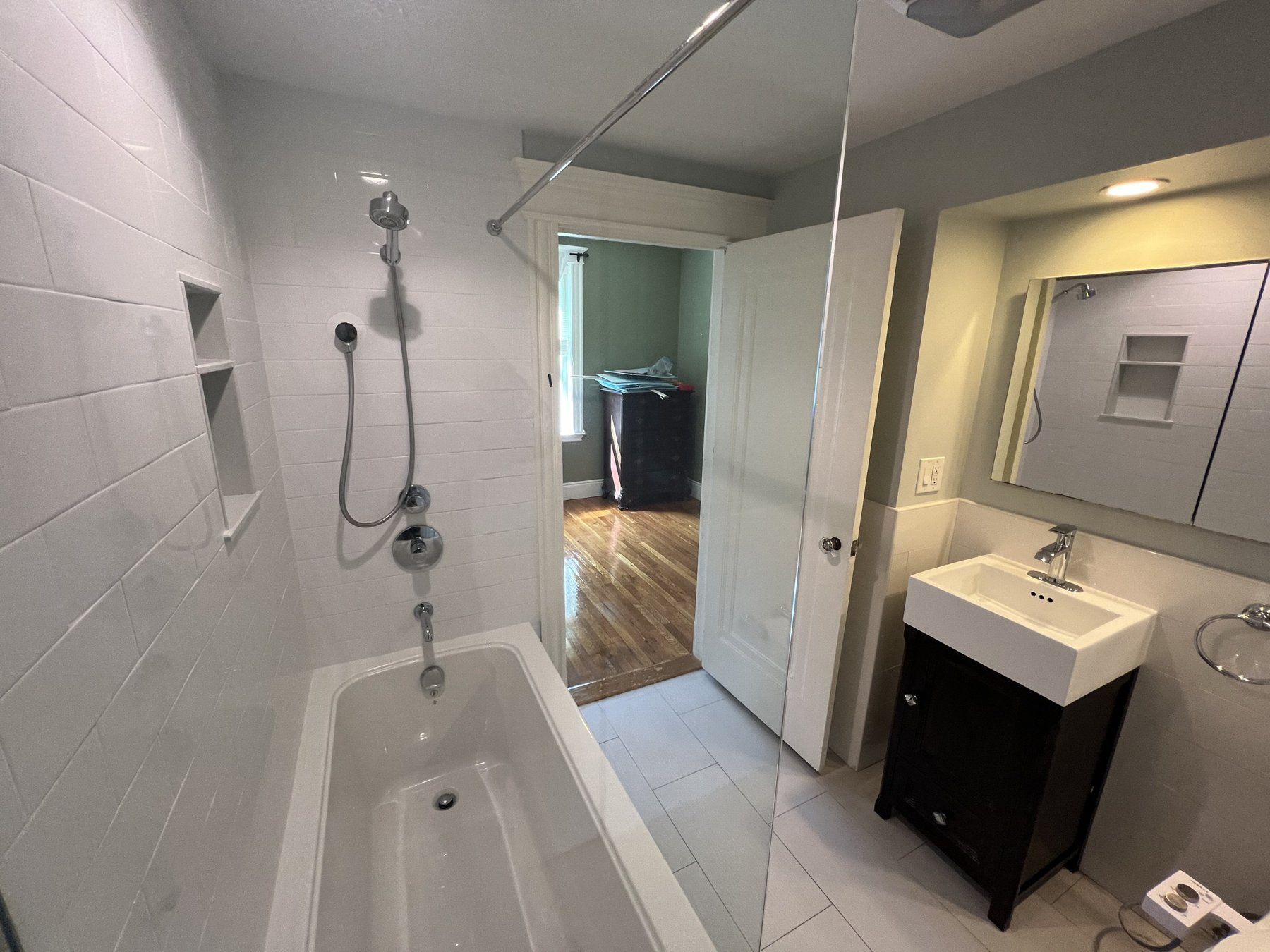 Tub-shower remodel with niche, glass panel and new vanity